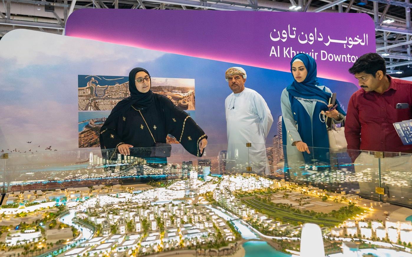 Visitors at a city model stand at the last Urban October