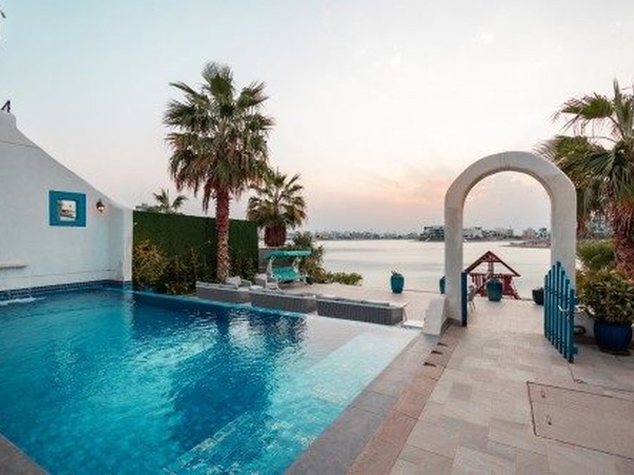 A chalet by the canal in Sabah Al Ahmad Sea City at sunset