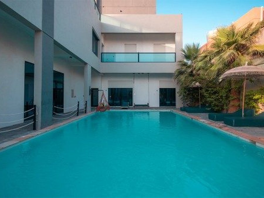 Pool and garden with the sea behind, Al Khiran