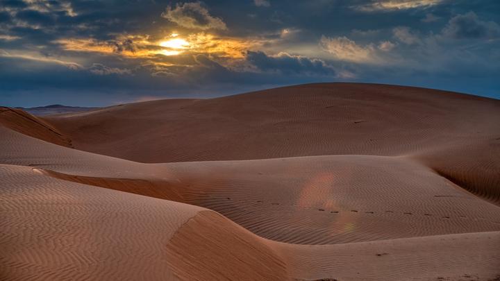 Sunset over the rippled dunes of the Sharqiya Sands