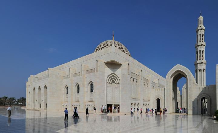 White marble walls, dome and minaret of the Sultan Qaboos Grand Mosque in Muscat