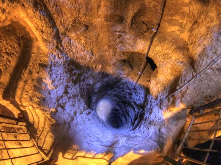 A lit shaft and carved stairway inside Derinkuyu underground city, Cappadocia