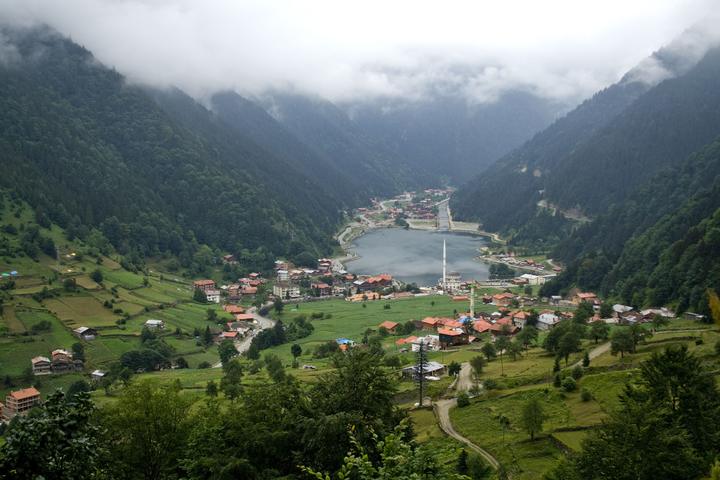 Uzungöl lake and village in a green valley with mist on the mountains, Trabzon