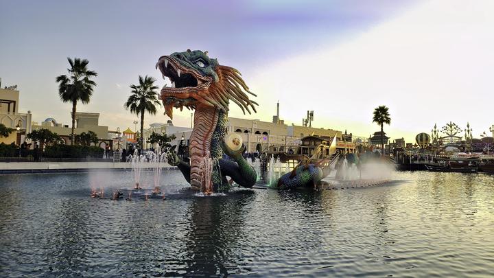 The dragon fountain at Global Village at dusk
