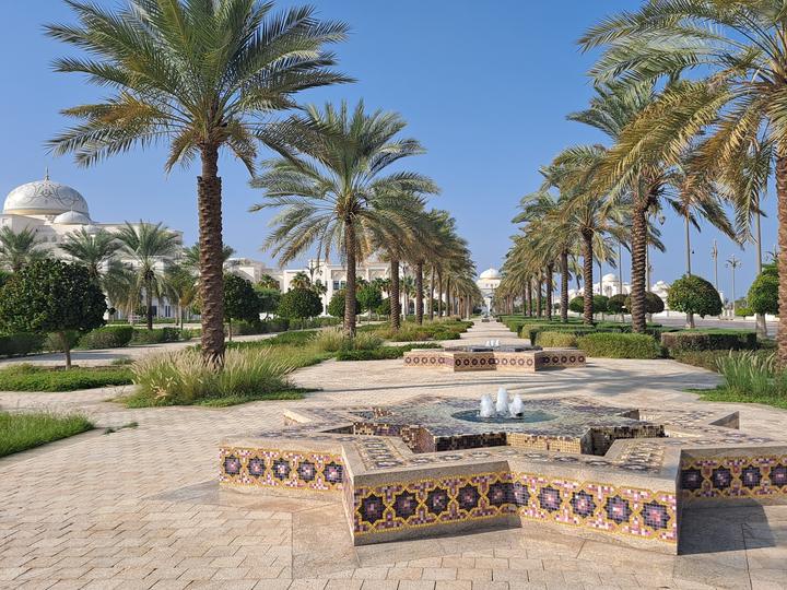 Palm avenue and star fountain in front of the domes of Qasr Al Watan