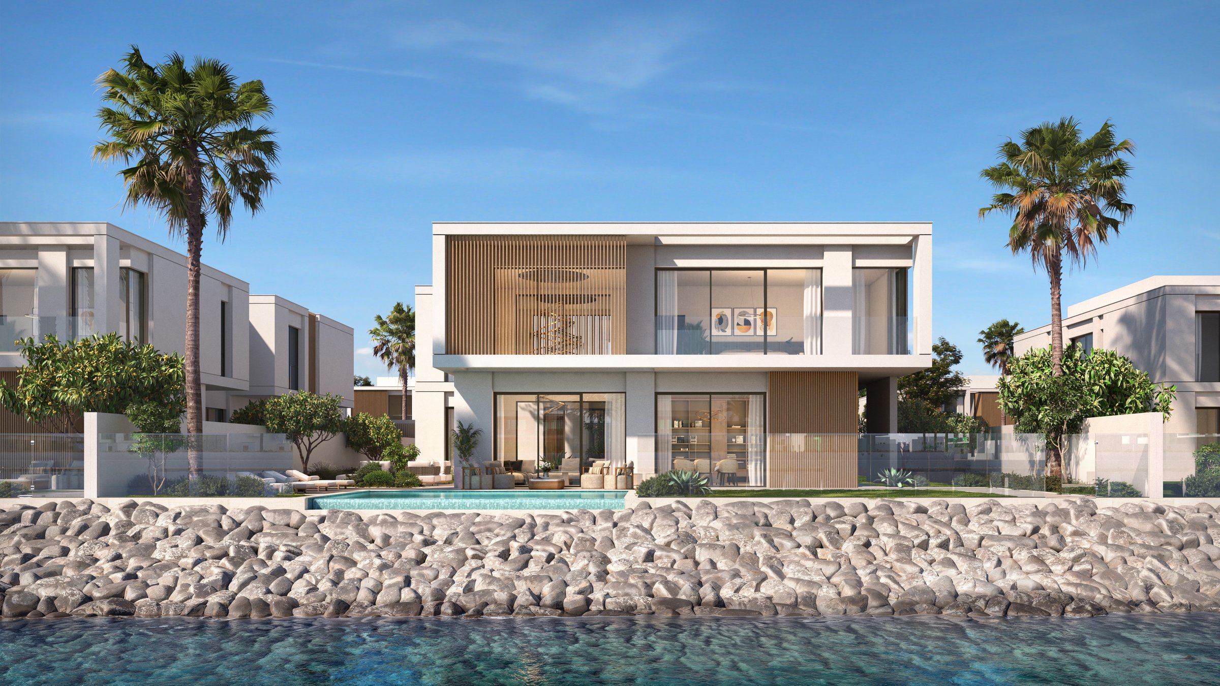Computer-generated image of a two-storey waterfront villa at Yas Riva Reserve by Aldar on Yas Island, Abu Dhabi: white walls with timber screens, a pool terrace, a rock-lined canal edge and palm trees